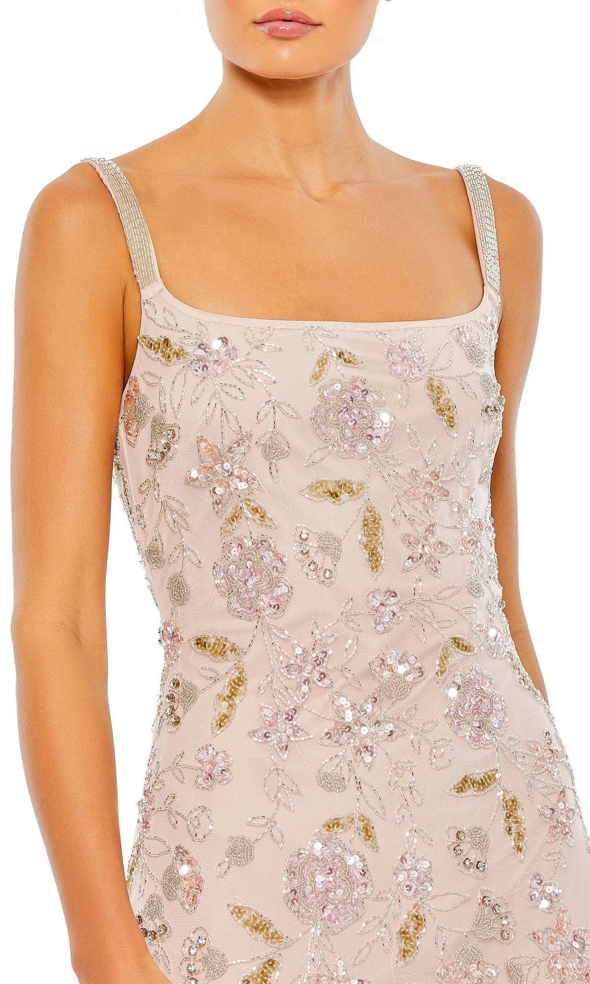 A woman wearing the Long Formal Dress 10808 by Mac Duggal featuring a sleeveless, pale pink design with silver straps, floral sequin embroidery, and an elegant open back.